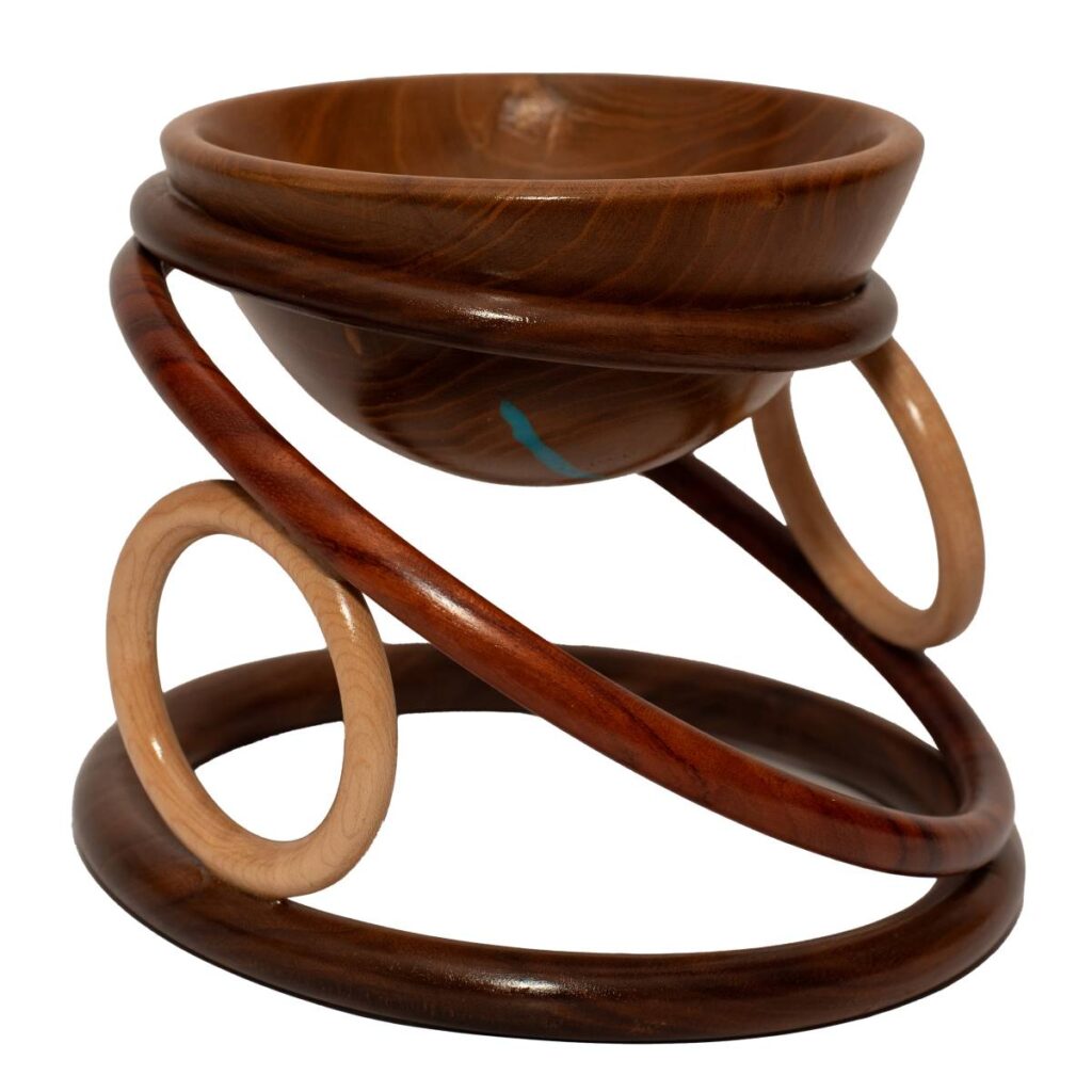 Dark Wooden Bowl Supported by an Artistic Base of Interlocking Wooden Rings in Different Shades