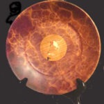 A Handcrafted Wooden Decorative Plate with a Rich Marbled Reddish-Brown Pattern