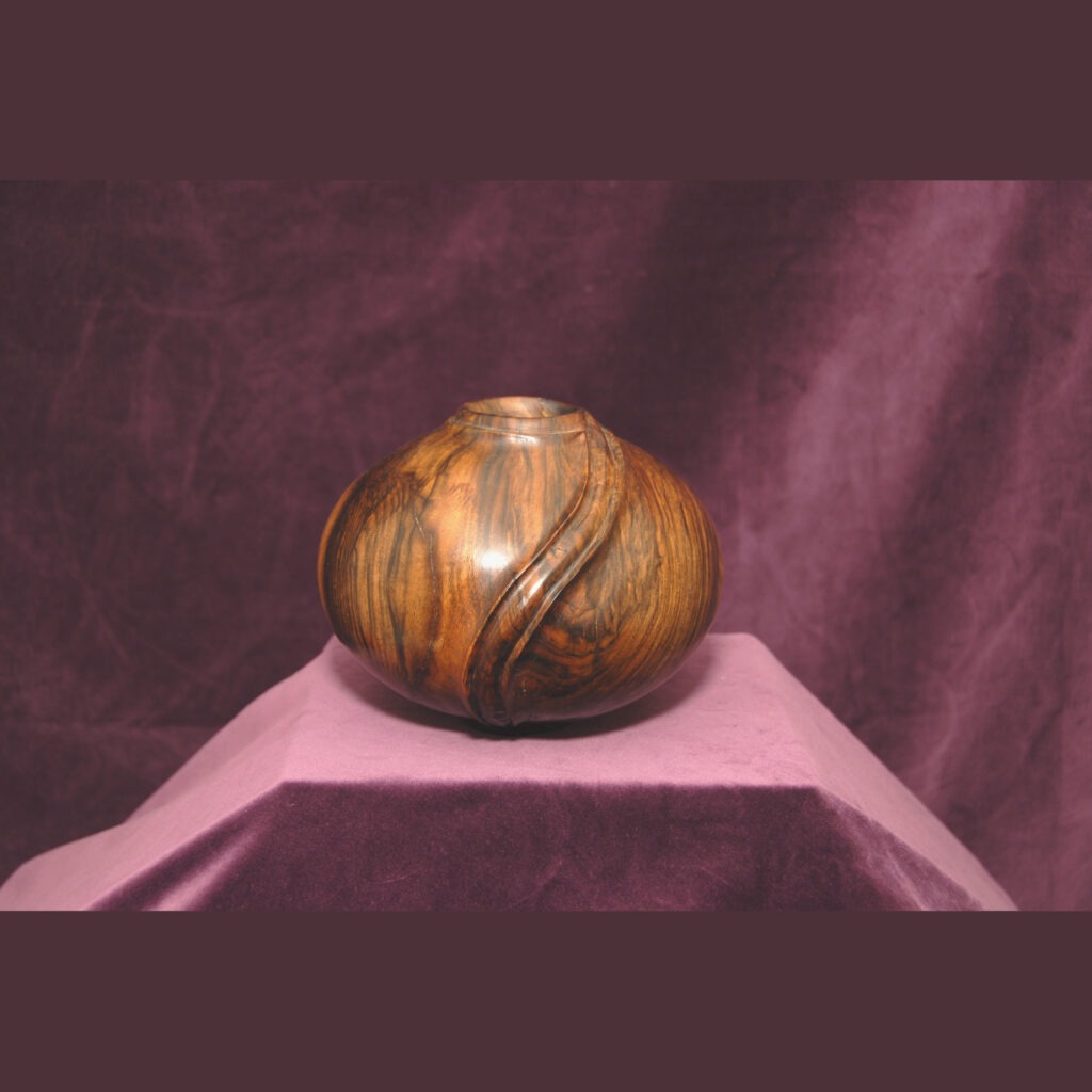 A Round Handcrafted Wooden Vase with a Smooth Polished Surface