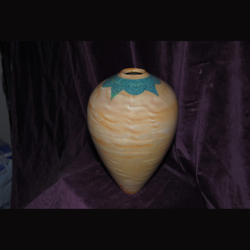 Tan Ceramic Vase with a Glossy Surface and a Textured Green Decorative Design Around the Narrow Opening at the Top